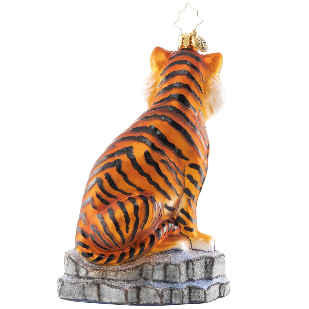 Back - Ornament Description - The Coolest Cats: Tigers live in diverse habitatsâ€”from rain forests, grasslands, savannas and mangrove swampsâ€”but this pair of majestic tigers stun even in the winter snow. Tigers are under threat from human activities such as poaching, illegal trade, and habitat destruction. A percentage of the sales from this ornament will benefit global initiatives to combat tiger trafficking.