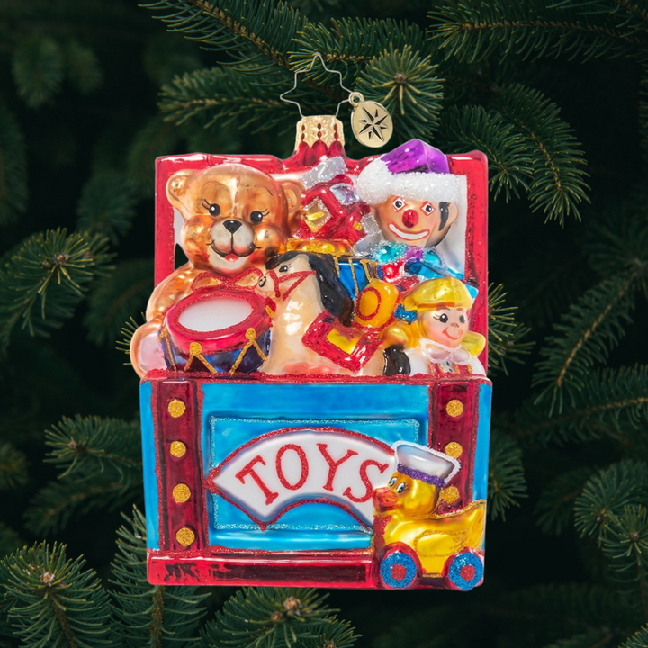 Ornament Description - Treasured Toybox: Open the lid and who knows what surprises await you inside! This vibrant toy chest is filled to the tippy top with Christmas treasures for every good girl and boy.