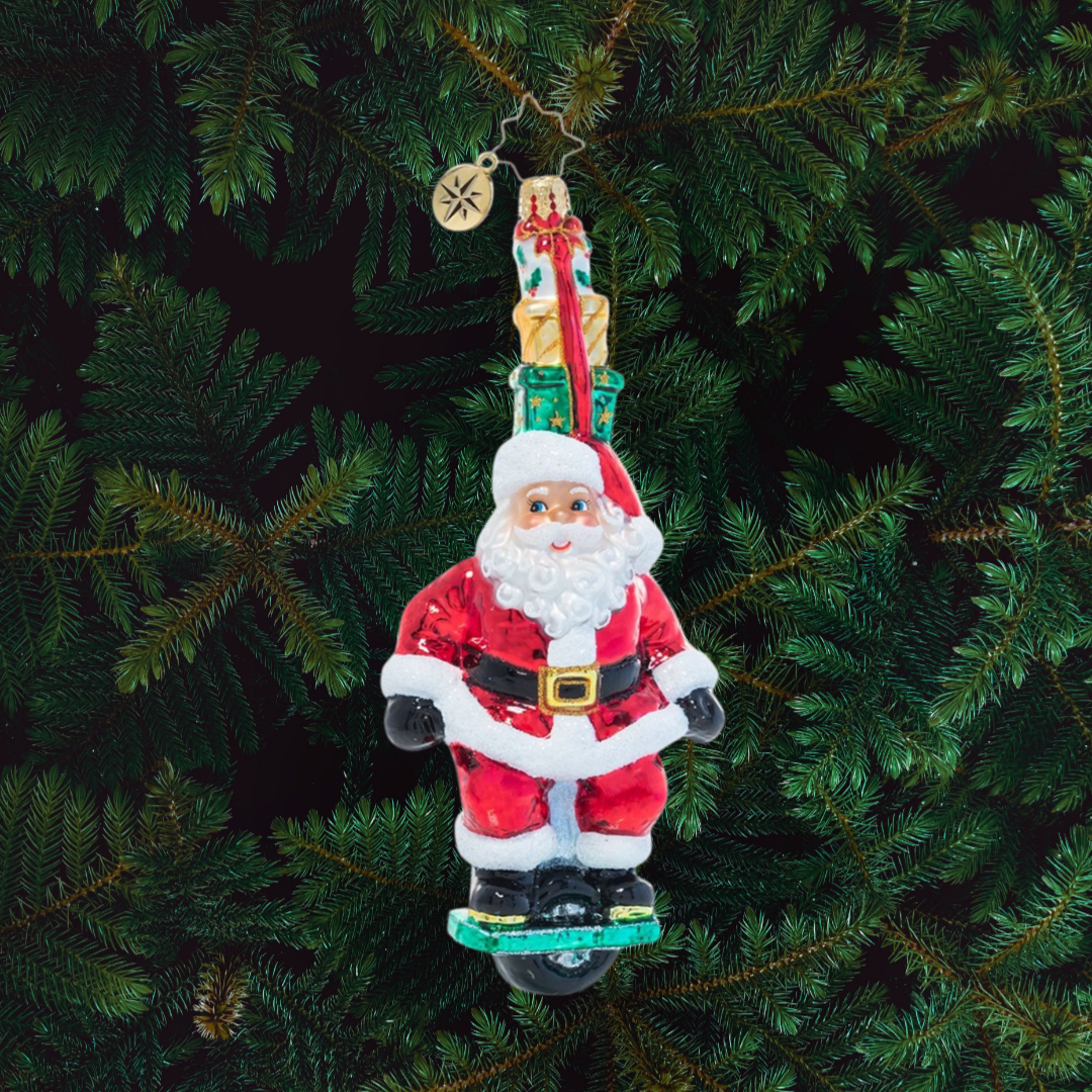 Ornament Description - One Wheelin' Santa: Proving you're never too old to learn new tricks, Santa expertly rides a single wheel while balancing a stack of gifts on his head. Is there nothing this guy can't do?