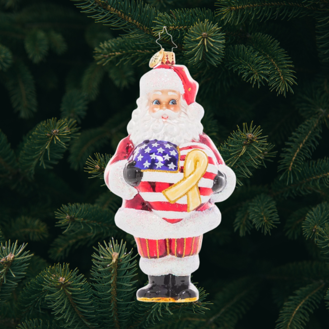 Ornament Description - Thank A Vet: Santa holds a star-spangled heart and with a yellow remembrance ribbon to show his heartfelt gratitude and respect for our brave veterans. Have you thanked a vet today? A percentage of the sales from this ornament will benefit Veteran’s charities.