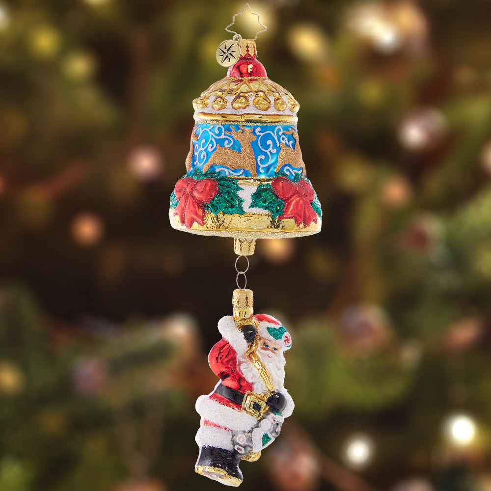 Ornament Description - Swinging Santa: Swinging from a beautiful Christmas bell adorned with deer and red roses, Santa is ringing in the holiday for all to hear.