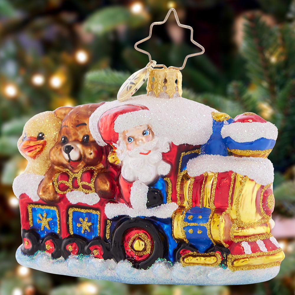 Ornament Description - Choo Choo Express Gem: Santa is chugging though the snow with his train full of toys, moving full steam ahead to deliver them to the good little girls and boys!