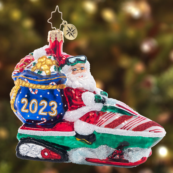 Ornament Description - Vroom Vroom Santa: Santa has the need for speed! He'll deliver presents in half the time this year thanks to his new snow-mobile.