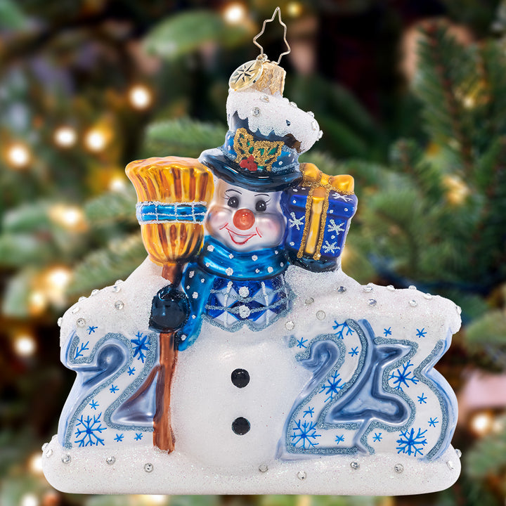Ornament Description - Coolest Year Yet: This chilly chum is predicting that 2023 will be the coolest year yet! Celebrate the holiday season with this stunning, snow-covered ornament.