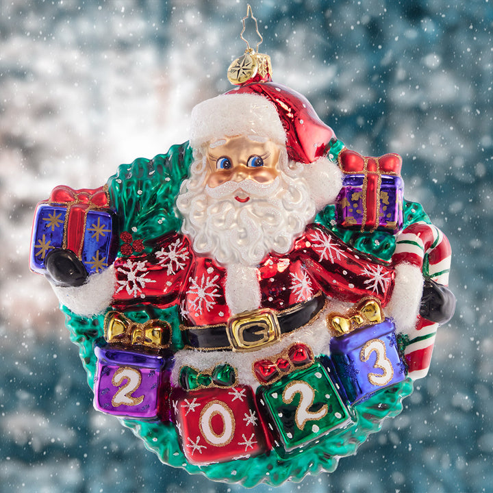 Ornament Description - Yearly Salutations: With arms spread wide full of Christmas cheer, Santa is looking ahead to an extra bright year! Adorn your tree with this darling dated piece.