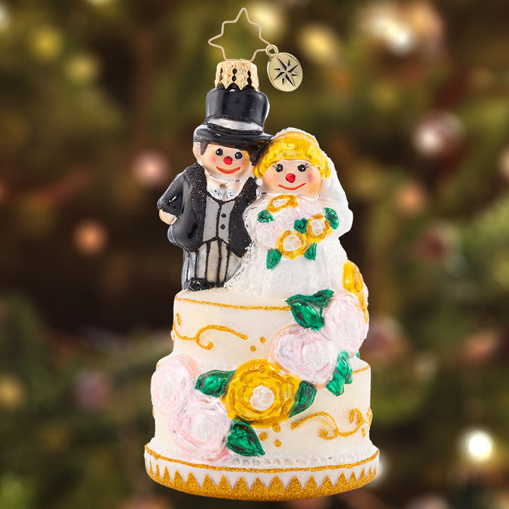 Ornament Description - Dearly Beloved: The perfect bride and groom pair is all dressed up with great flair. This marvelous cake topper is quite the wedding showstopper!