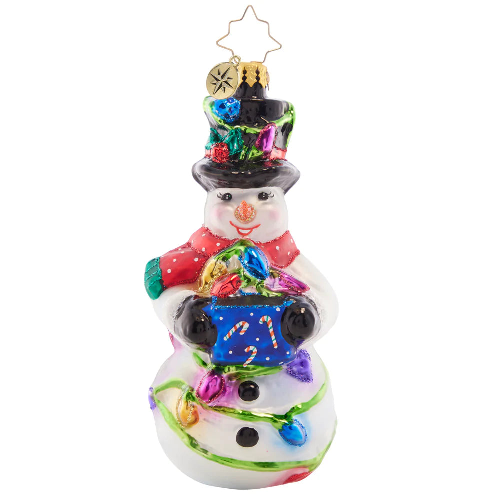 Front - Ornament Description - Light The Night Snowman: This smiling snowman has his work cut out for him with a big bundle of holiday lights – ready to deck the halls and shine bright through the night!