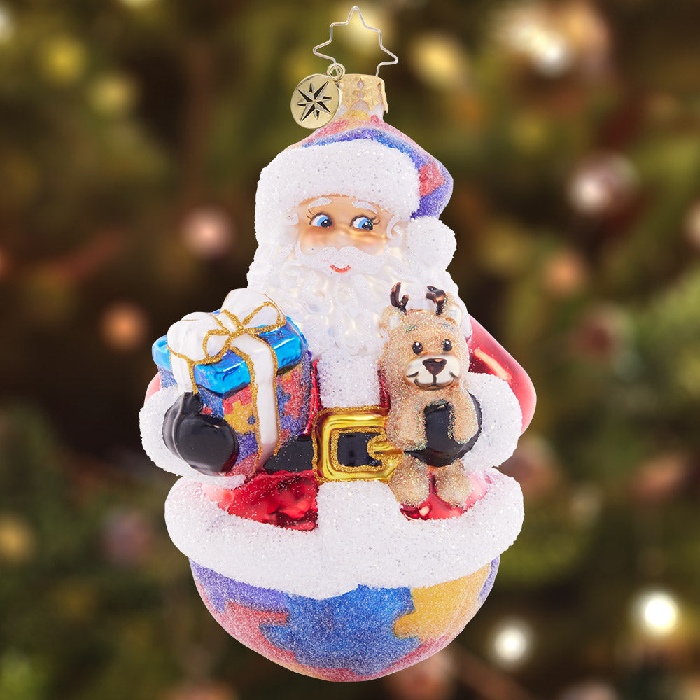 Ornament Description - Perfect Pieces: This perfectly unique puzzle piece santa celebrates the strength and beauty of neurodiversity. A percentage of the sales from this ornament will benefit a charity that raises Autism awareness.