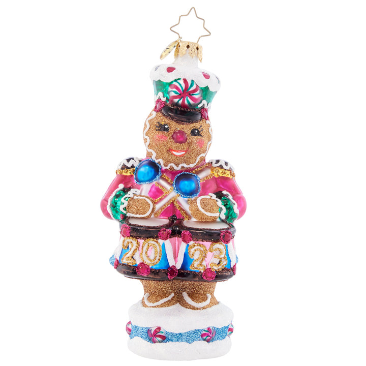 Front - Ornament Description - Drumroll Please: A gingerbread guard gallantly protects the candy castle, ensuring that it outlasts hungry hands of good little girls and boys before Christmas day.
