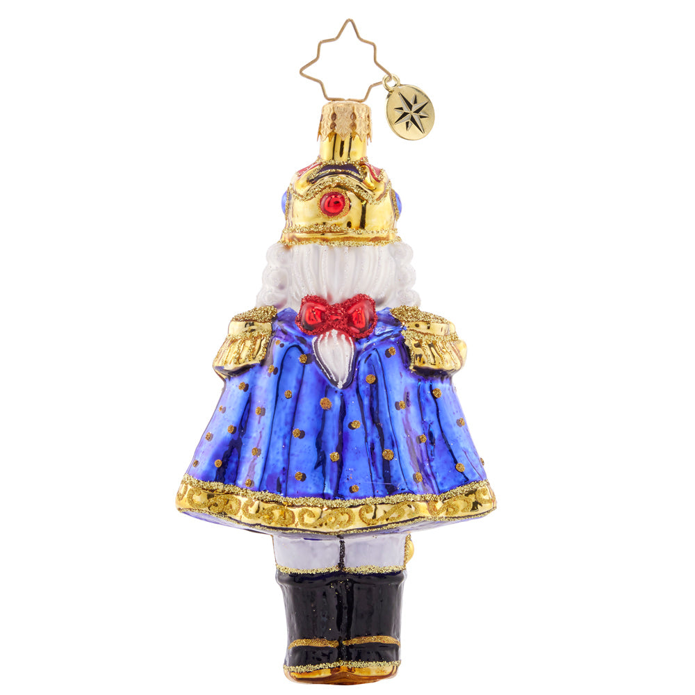 Back - Ornament Description - Christmas Classic 'Cracker: Time to get crackin' on some present unwrapping! This classic nutcracker is ready to celebrate, marvelously mustachioed and donning a red and blue cloak.