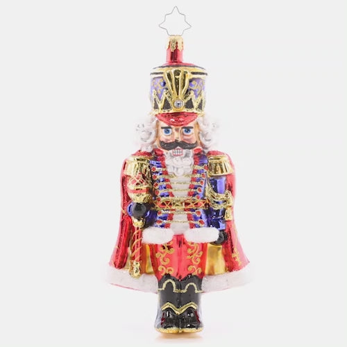 Video - Ornament Description - Holiday Elegance Nutcracker: With his royally resplendant red cape, this classic Christmas nutcracker is the perfect protector to place among the boughs of your tree. This video shows the ornament slowly spinning. 