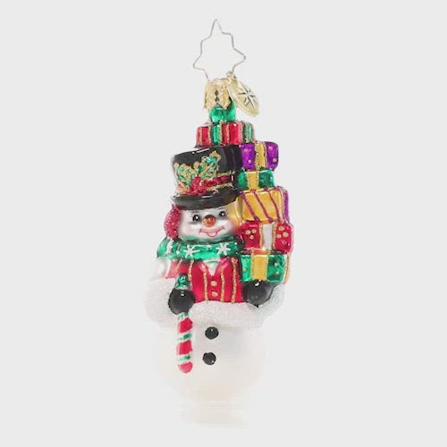 Video - Ornament Description - Savvy Shopper Gem: This snowman takes Christmas shopping very seriously! He's spent his day finding just the right gifts for everyone on his list – time to return home to put them under the tree! This video shows the ornament spinning slowly. 