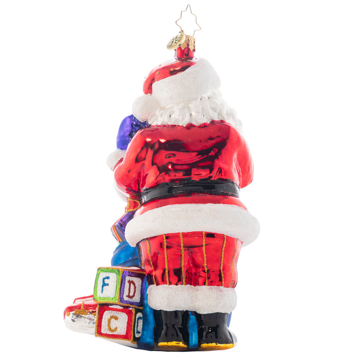 Back - Ornament Description - Santa's Special Gift to You: Whatever it takes to treat it--a toy, a kiss, a visit from a friend. Your child deserves wholeness on the holiest of days. Add a name or holiday wish to Santa's bag of treats to make the is truly unique piece. Note: Please allow approximately one month (on top of shipping time) for our elves to personalize your ornament.