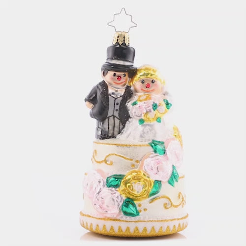 Video - Ornament Description - Dearly Beloved: The perfect bride and groom pair is all dressed up with great flair. This marvelous cake topper is quite the wedding showstopper! The video shows this ornament slowly spinning