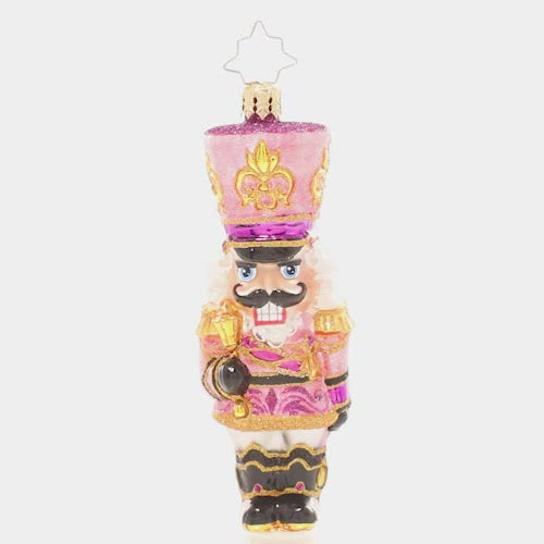 Video - Ornament Description - Flushed With Pink - This jaunty pink sparkly nutcracker is ready to add some pizazz to the tree this year. Let's get cracking!