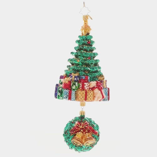 Video - Ornament Description - Christmas Splendor Tree: It's beginning to look a lot like Christmas! A glitzy Christmas tree peeks out above a giant pile of presents, with a musical wreath poised beneath.